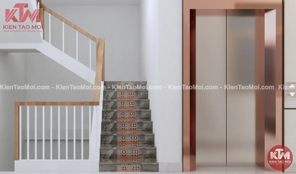 Cầu thang tay vịn gỗ nội thất nha khoa cạnh thang máy ốp đồng