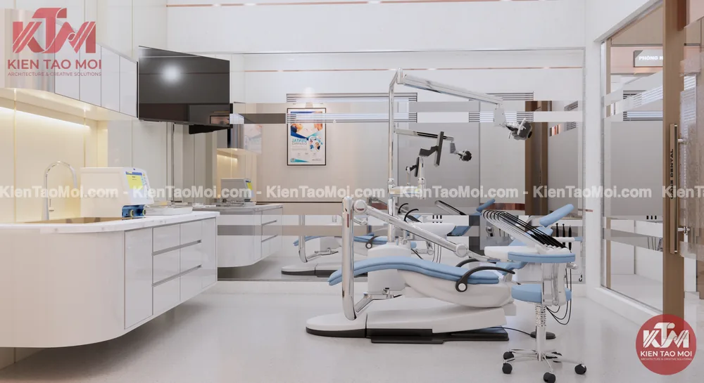 Phòng điều trị nội thất nha khoa với ghế xanh, đèn khám và tủ dụng cụ trắng