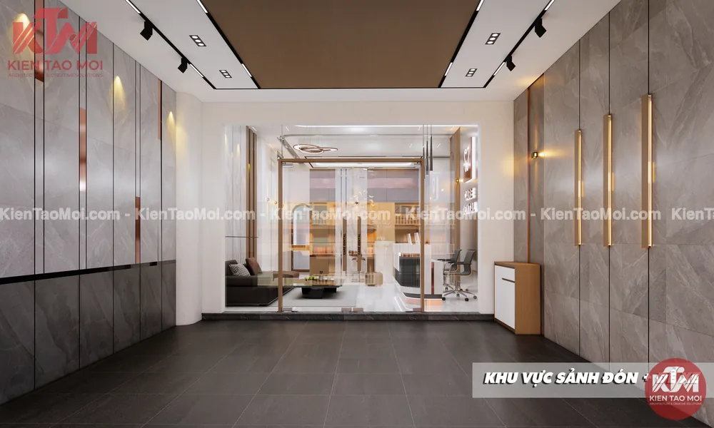 Sảnh đón trong thiết kế phòng khám nha khoa, tường đá xám và đèn hắt vàng